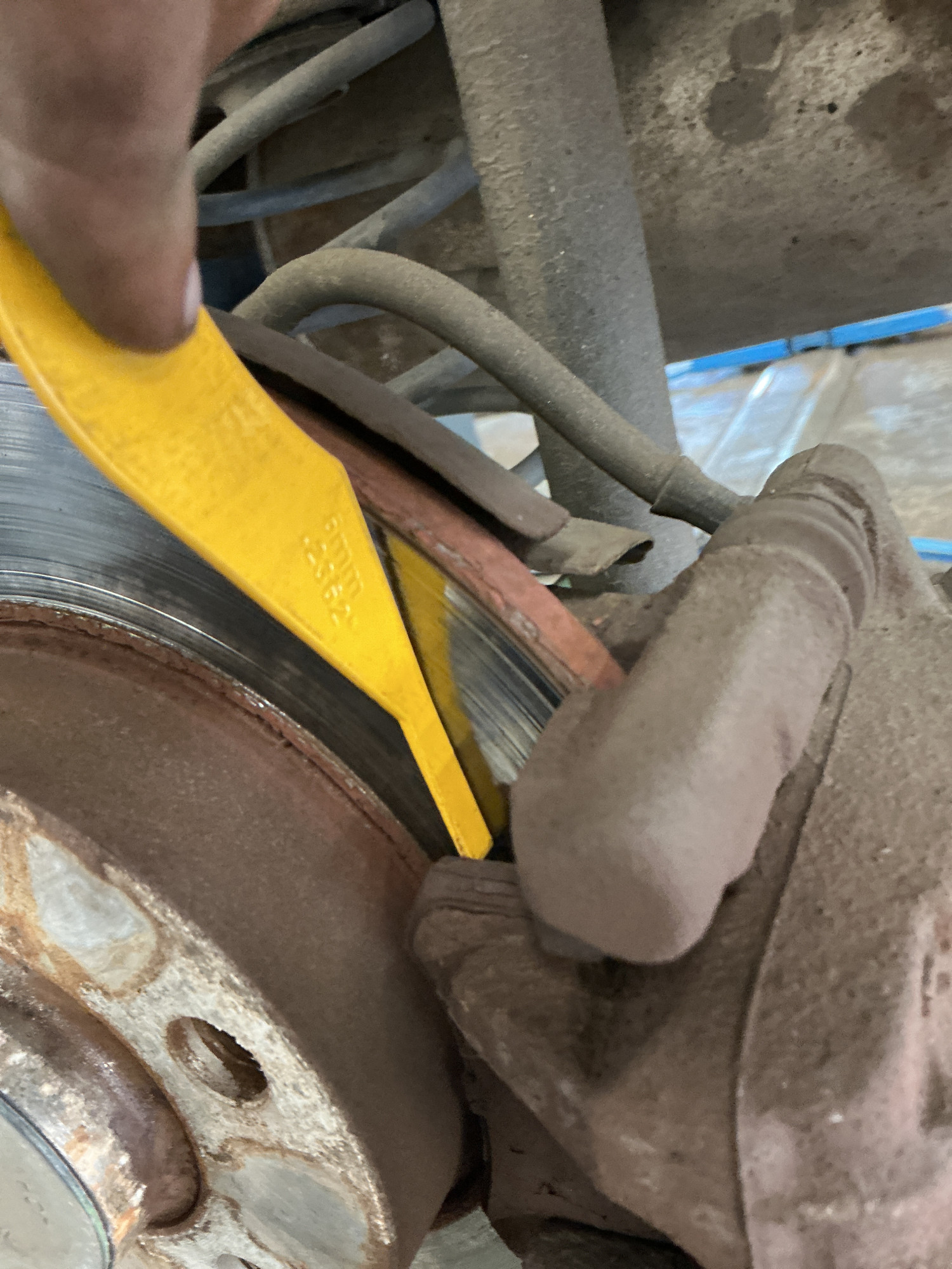 Brake pad thickness gauge measuring remaining friction material