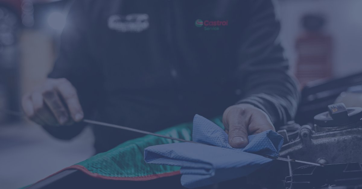 Lindleys Autocentres technician in Castrol overalls checking engine oil during a car service in Nottingham