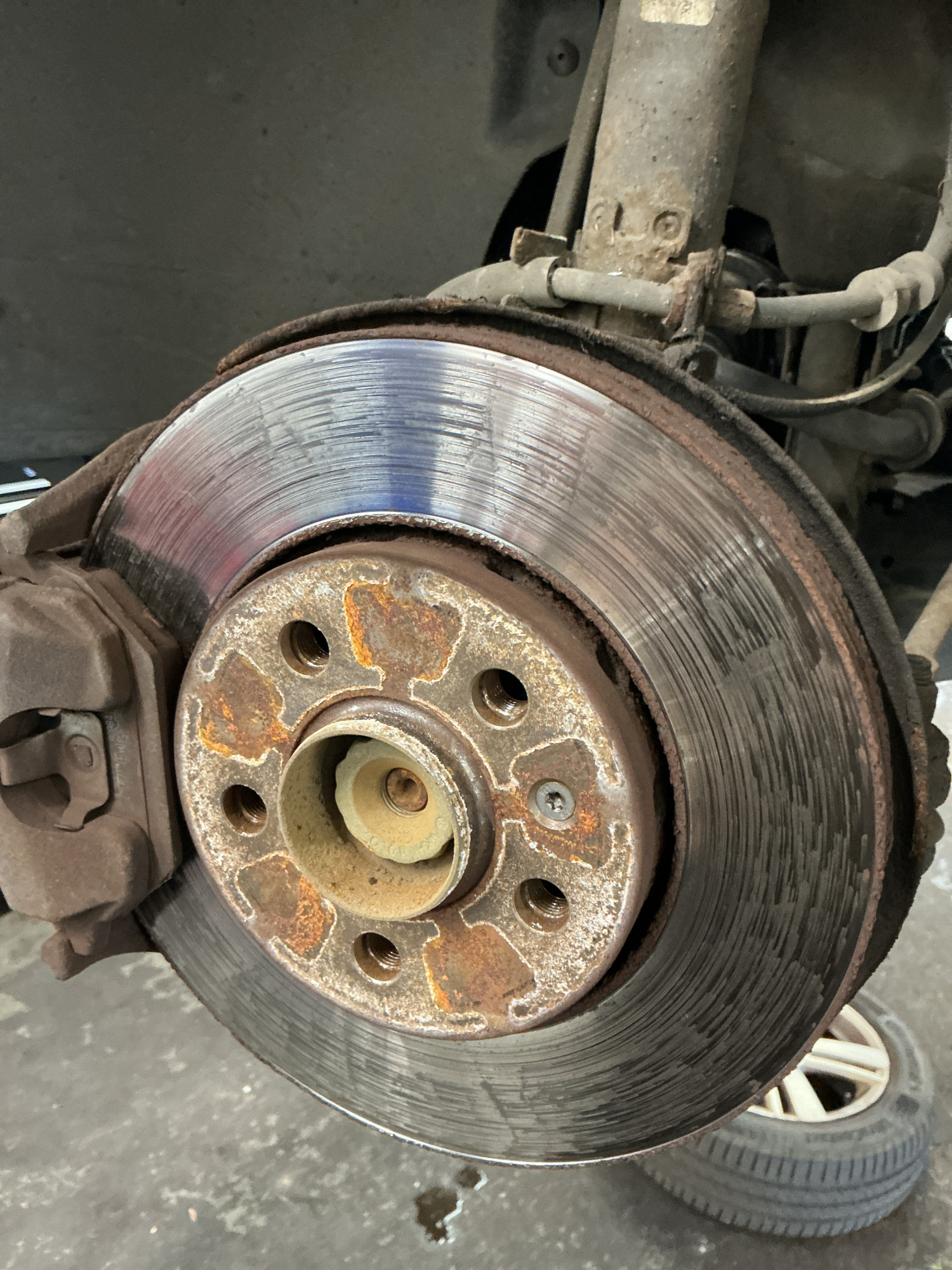 Heavily corroded and lipped rear brake disc