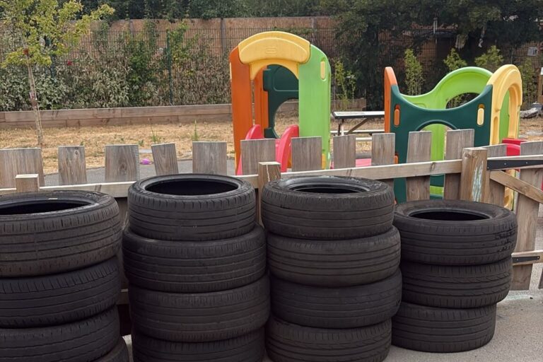 Free scrap tyres beside the playground at a Nottinghamshire nursery Stacks of scrap tyres ready for play beside the playground at a Nottinghamshire nursery