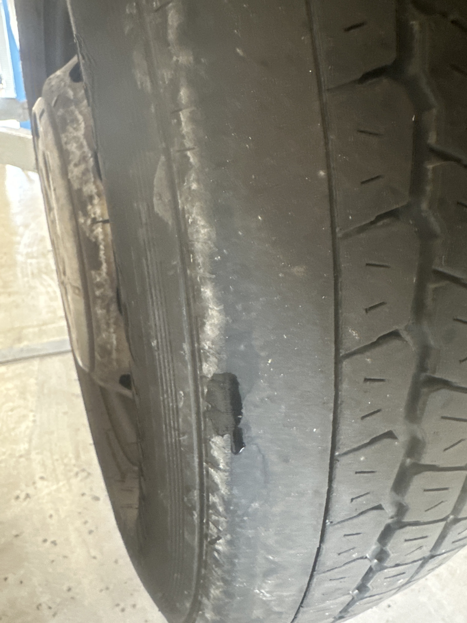 Sidewall damage with a chunk of rubber missing from a tyre