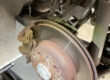 Rear brake disc and caliper on a car raised on the ramp during a parking brake efficiency investigation