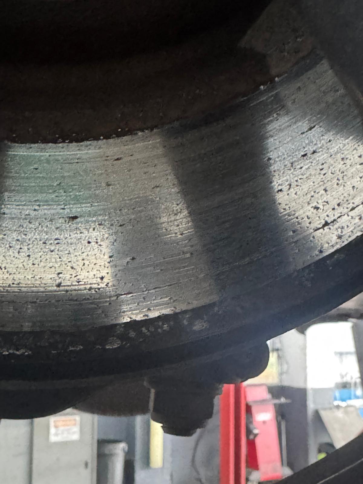 Corroded and pitted brake disc friction face on a Tesla in the workshop at Lindleys Autocentres