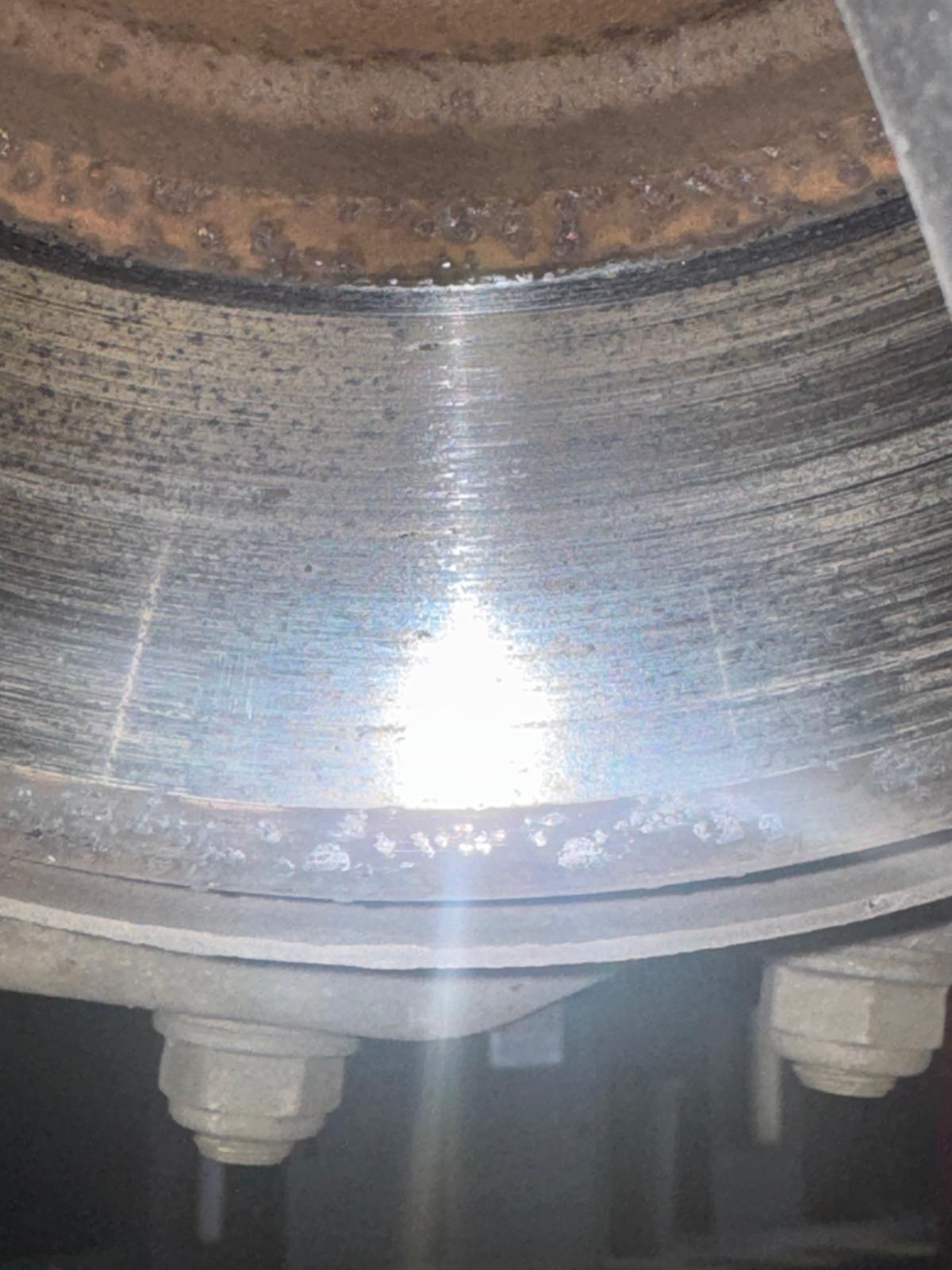 Brake disc showing rust around the hub and a corroded lip at the edge of the braking surface
