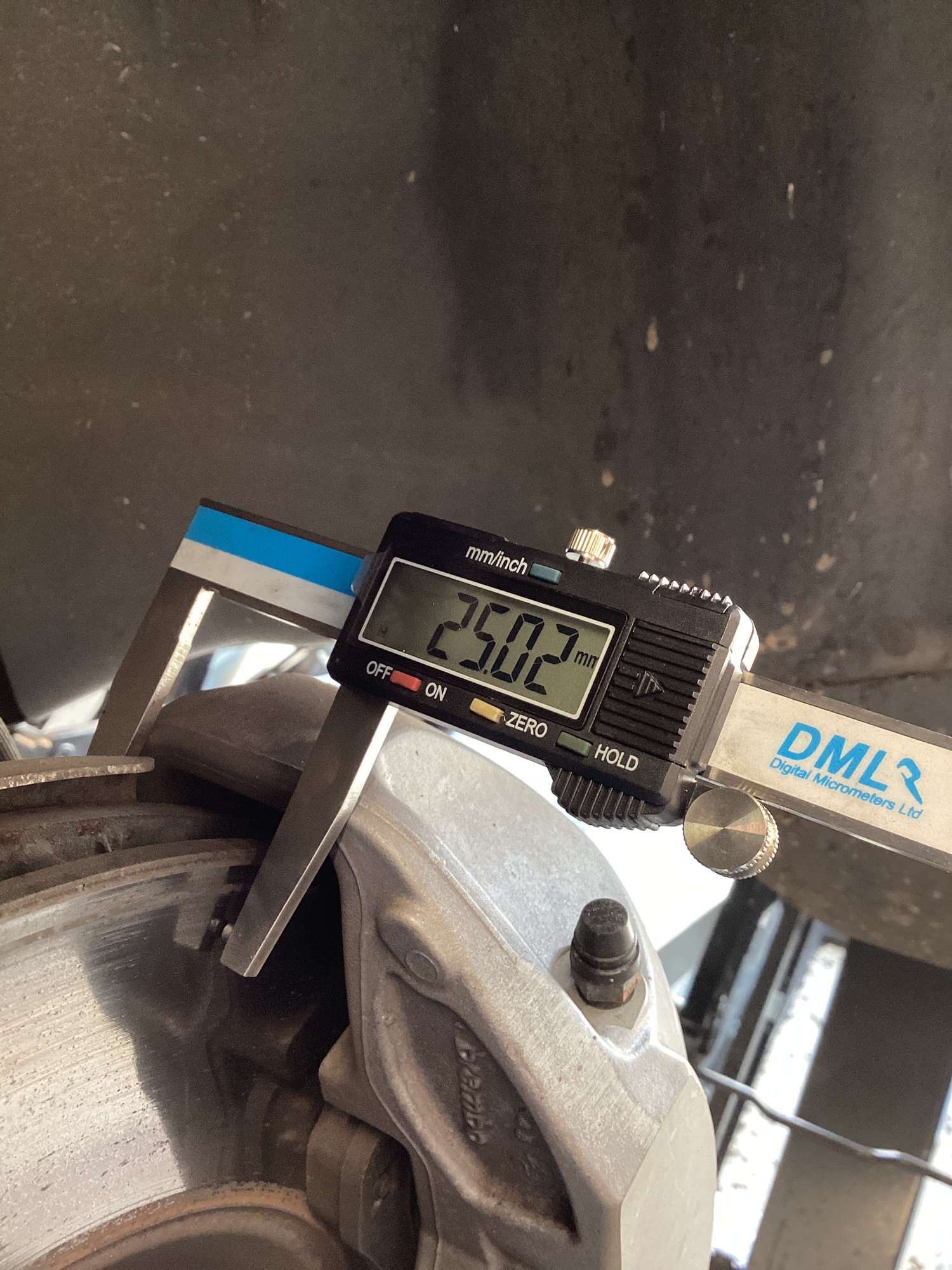 Digital micrometer measuring brake disc thickness on a Tesla at Lindleys Autocentres