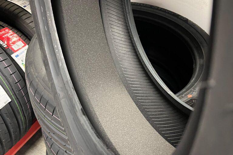 tesla-ev-tyre-acoustic-foam-noise-reducing.jpeg Cutaway view of an EV tyre showing the grey acoustic foam strip bonded inside the tread area