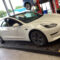 White Tesla Model 3 on the ramp inside the Lindleys Autocentres workshop in Nottinghamshire