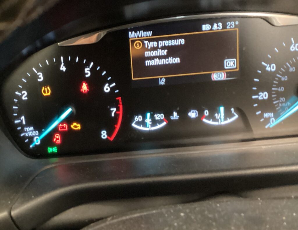 TPMS warning light and tyre pressure monitor malfunction message on a car dashboard