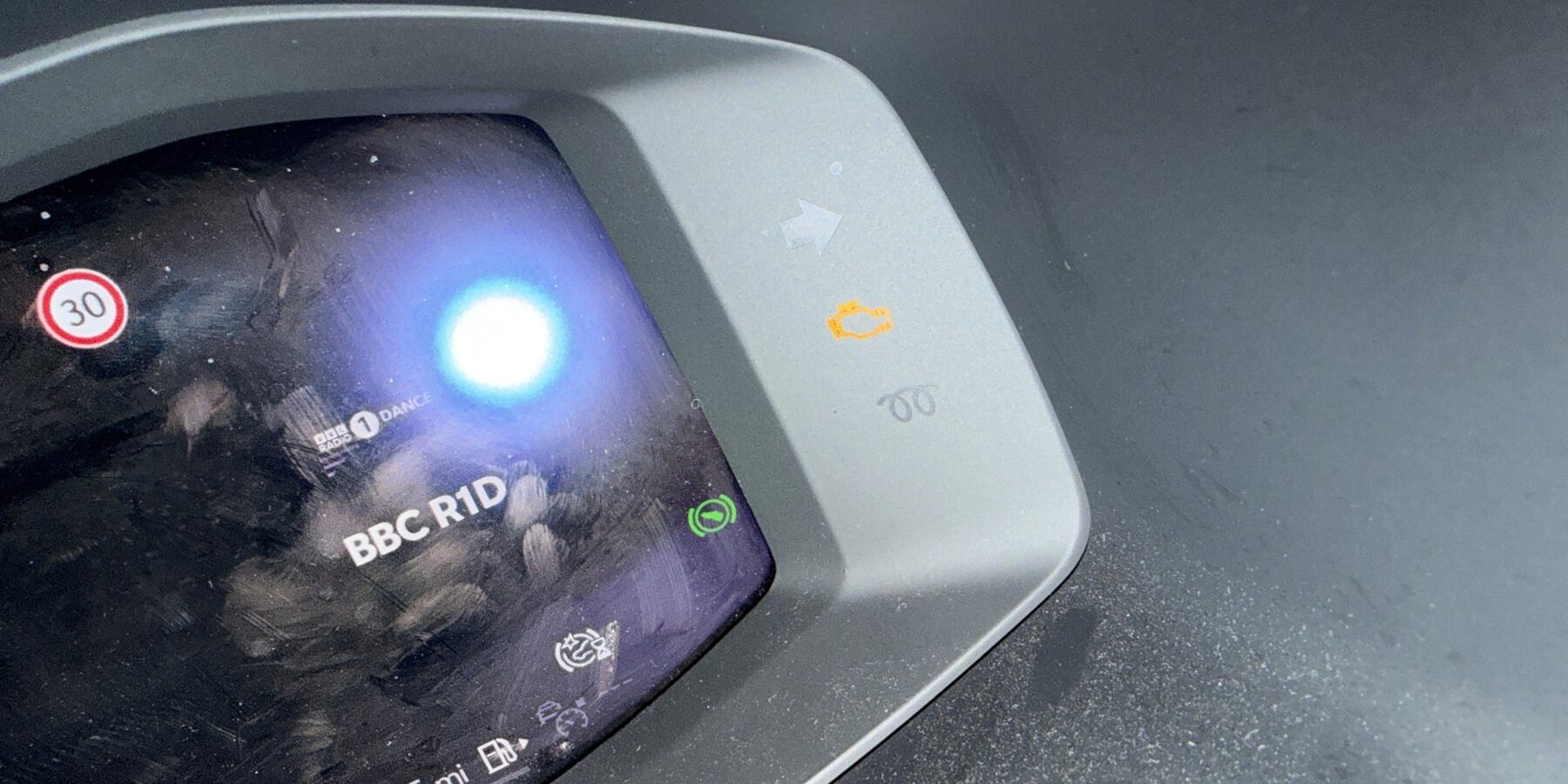 engine-management-light-on-dash Amber engine management light lit on a modern digital instrument cluster