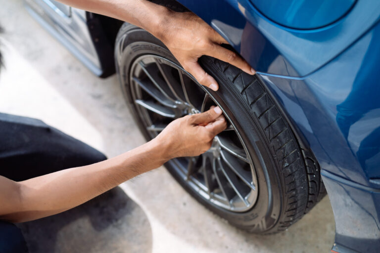 lindleys-mobile-alignment-tyre Technician checking a tyre on a car wheel
