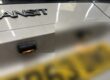 Two number plate lamps above the rear plate of a van's tailgate