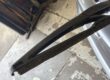 Rear wiper blade with its rubber split and hanging away from the arm
