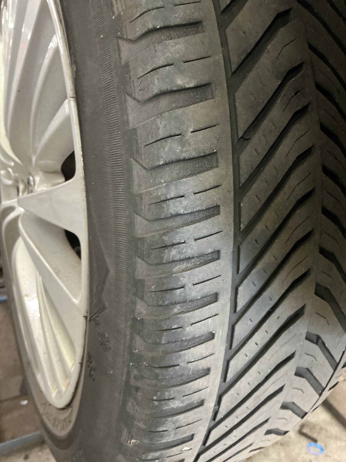 Cracking and perishing visible across the tread blocks of an ageing tyre