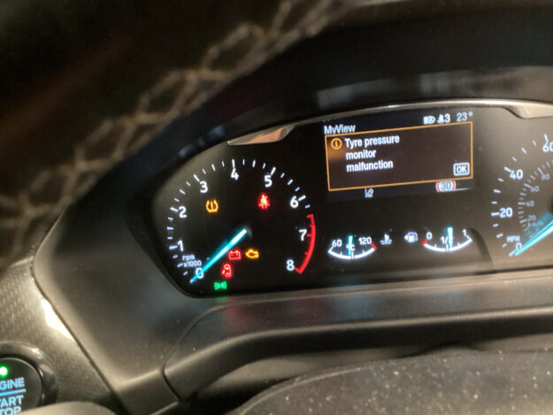 Ford instrument cluster showing a tyre pressure monitor malfunction message and the amber TPMS warning light