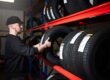 Lindleys technician taking a tyre from a rack of Churchill tyres in stock