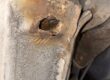 Rear sill corroded through with a hole near the suspension mounting