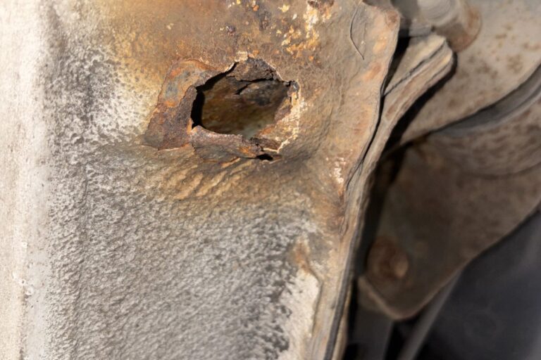 Rear sill corroded through with a hole near the suspension mounting