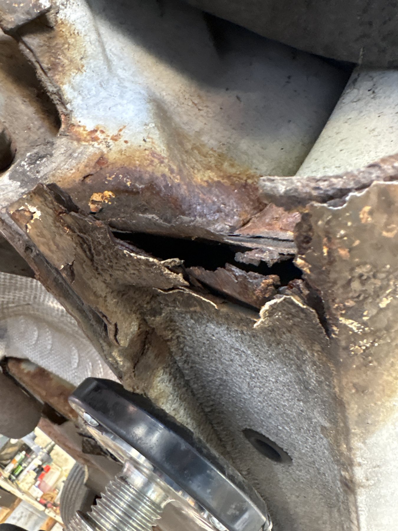 Corroded sill seam split open near suspension components
