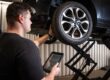 Lindleys technician checking a tyre and recording the results on a tablet