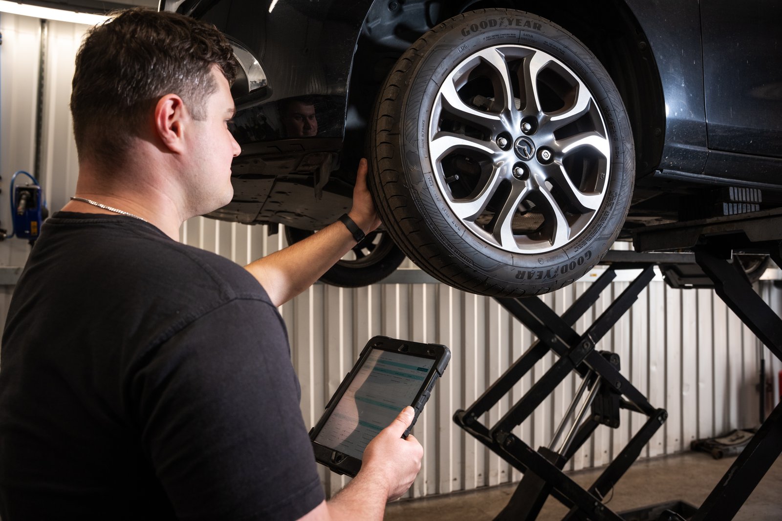 Lindleys technician checking a tyre and recording the results on a tablet